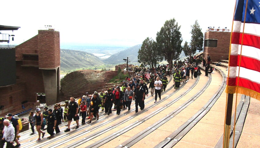 Participants, some of whom are firefighters wearing their bunker gear, walk through Red Rocks Amphitheatre to honor the 343 FDNY firefighters who lost their lives on 9/11.